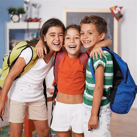 "Schoolchildren Hugging In Classroom" by Stocksy Contributor "Guille ...