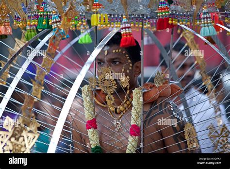 SINGAPORE - JANUARY 27: Male Hindu devotee carrying a kavadi at Thaipusam taken on January 27 ...