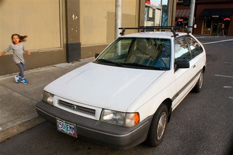 OLD PARKED CARS.: 1987 Mercury Tracer hatchback.