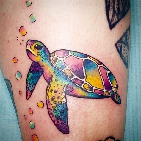 a colorful sea turtle tattoo on the leg