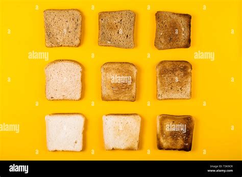 Different types of toast bread and various toasts in a toaster on a bright yellow background ...