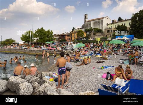 People sunbathing on beach in Desenzano del Garda, Italy Stock Photo ...