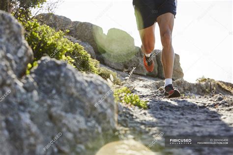 Male runner running on rocky trail — Front View, dedication - Stock ...