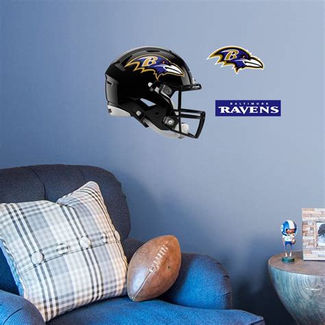 the baltimore ravens helmet is hanging on the wall next to a blue chair ...