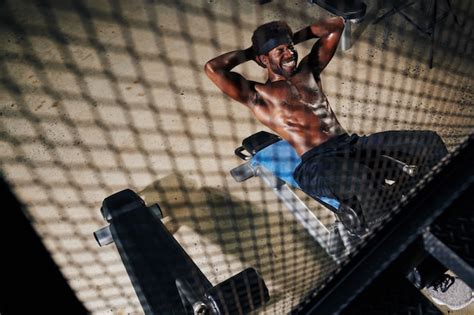 Premium Photo | Fit man doing sit-ups in gym