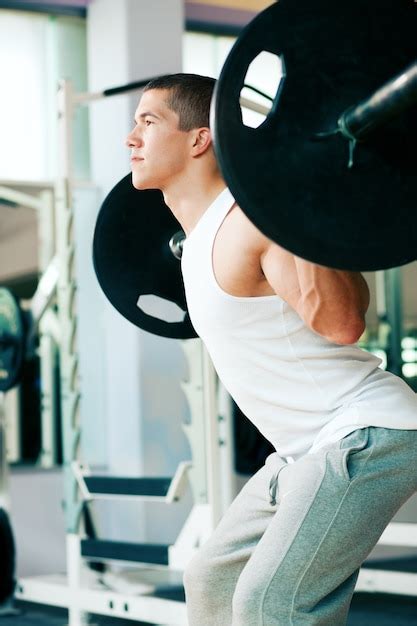 Premium Photo | Man lifting weights in gym