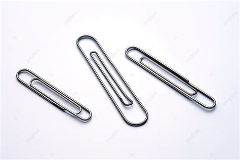 A Collection Of Three Paper Clip Shapes Laying On A White Surface ...