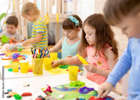 Art and craft activity in kindergarten. Preschool kids hands working in ...