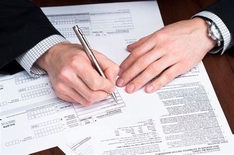 Men Filling Out Documents on a Desk. Stock Image - Image of office ...