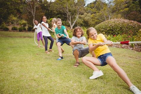 Premium Photo | Children pulling a rope in tug of war