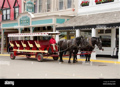 Michigan, Mackinac Island. Traditional horse carriage in downtown Mackinac Stock Photo - Alamy