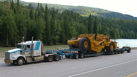 CAT Scrapper on a 2 axle jeep + 4 axle RGN trailer with pull out wings ...