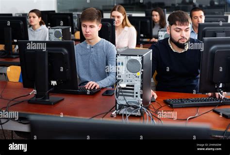 Group of people learning to use computers in classroom Stock Photo - Alamy