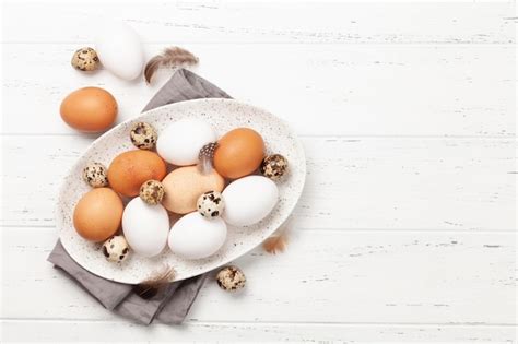 Premium Photo | White brown and quail eggs