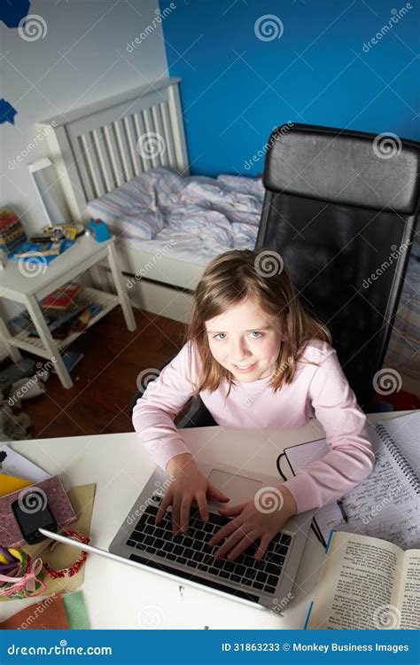 Girl Studying In Bedroom Using Laptop Stock Photos - Image: 31863233