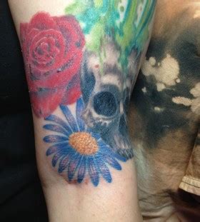 Skull, red with blue cornflower tattoo