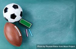 American Football And Soccer Ball On Cleaned Chalkboard With Writing ...