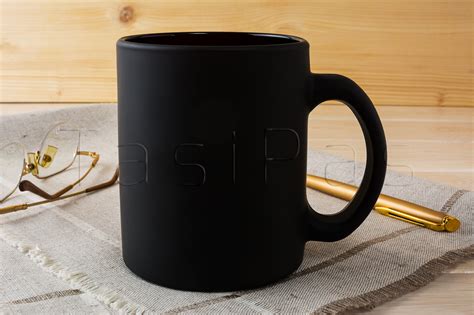 Black coffee mug mockup with glasses and pen