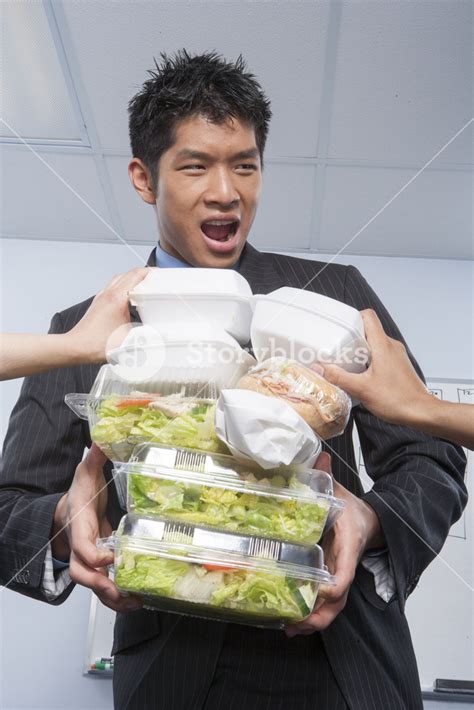 Businessman hoarding food Royalty-Free Stock Image - Storyblocks