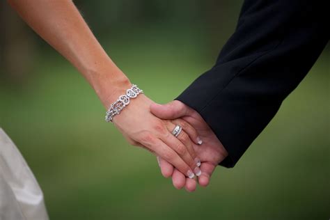 Bride and Groom Holding Hands/Rings | Wedding ring hand, Black wedding ...