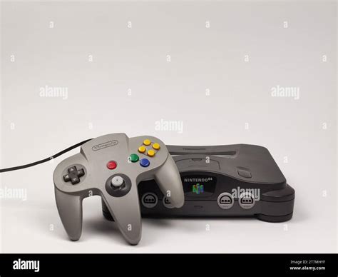 A gray Nintendo 64 retro console with a gray joypad is depicted on a ...