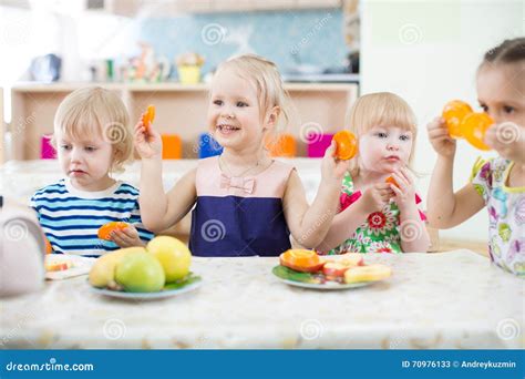 Funny Kids Eating Fruits in Day Care Centre Stock Image - Image of lunch, happy: 70976133