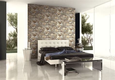 Layered stone wallpaper in a modern bedroom with white bed. From Wallquest's collection ...