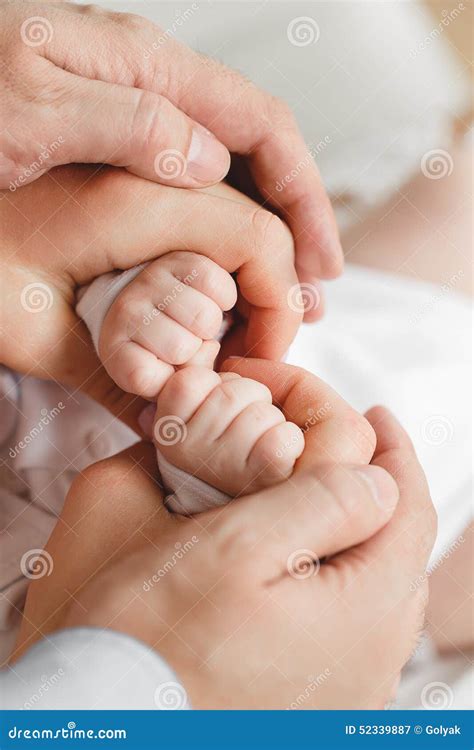 Closeup Of Baby Hand Into Parents Hands. Family Concept Stock Photo ...