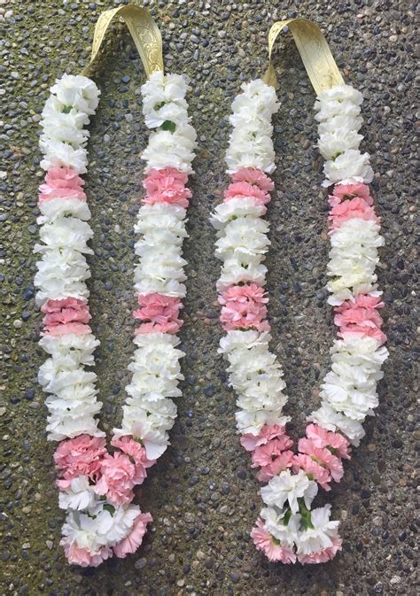 Soft garlands consisting of soft pink and white carnations with gold ...