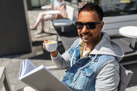 Man Reading Book and Drinking Coffee at City Cafe Stock Image - Image of book, literature: 153657775