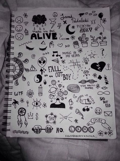 a notebook covered in stickers on top of a sheet of paper with the ...