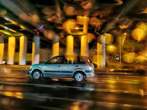 Premium Photo | Street car in motion on a night road