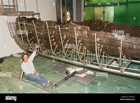 Researcher with ancient Galilee boat at the Yigal Allon Centre (Jesus Boat Museum) on the shores ...