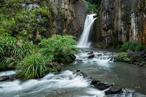 Tall waterfall in tropical forest in valley · Free Stock Photo