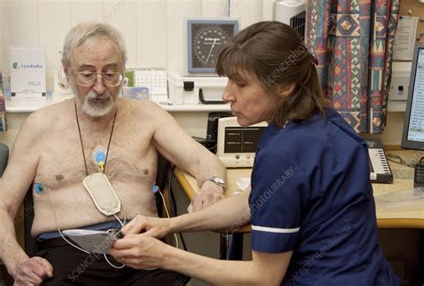 Ambulatory ECG being fitted - Stock Image - C013/5233 - Science Photo Library