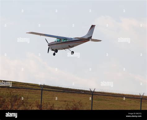 small propeller plane landing at an airport Stock Photo - Alamy