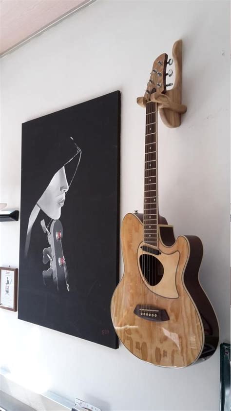 Guitar Hangers in solid wood, to be fixed to the wall with a single hidden screw, in addition to ...