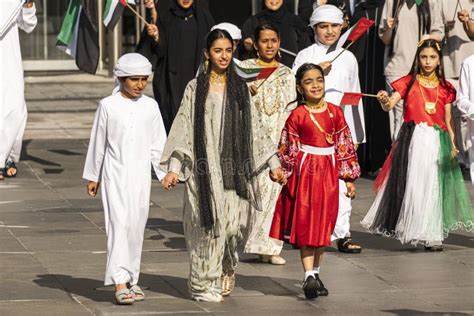 Children in Traditional Clothes Wave Flags of the United Arab Emirates ...