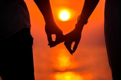 Premium Photo | Love - romantic couple holding hands, beach sunset ...