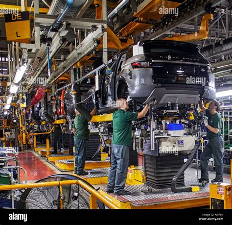 Workers on engine production line in car factory Stock Photo - Alamy