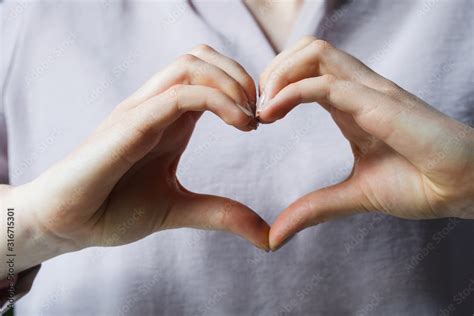 heart shape hand sign, young girl making heart with two hands Stock Photo | Adobe Stock