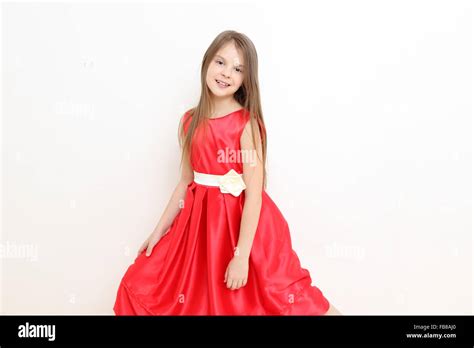 Pretty little girl wearing red dress Stock Photo - Alamy