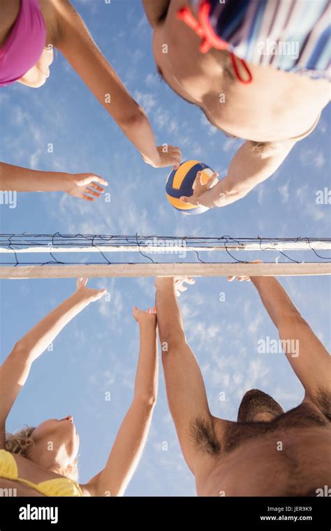 Friends playing beach volleyball Stock Photo - Alamy