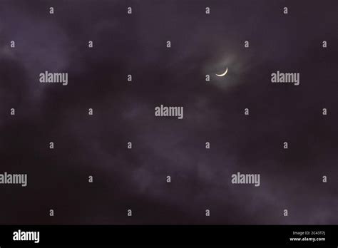 crescent moon in clouds at night Stock Photo - Alamy