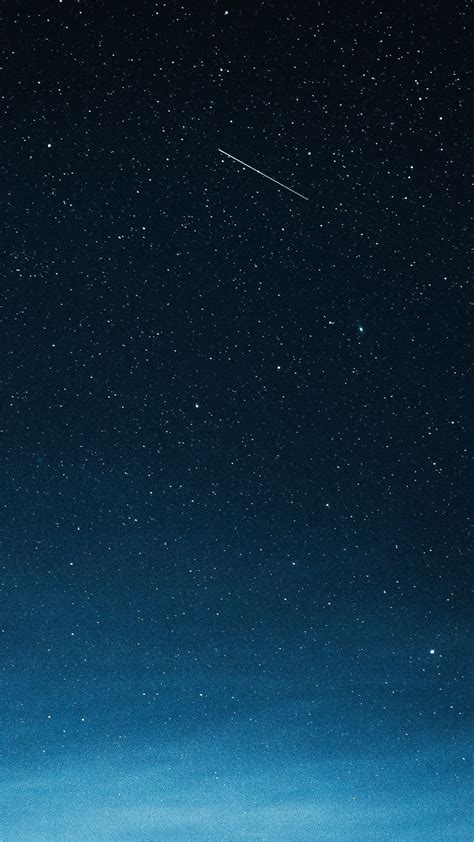 Download premium image of Shooting star in the dark blue sky over ...