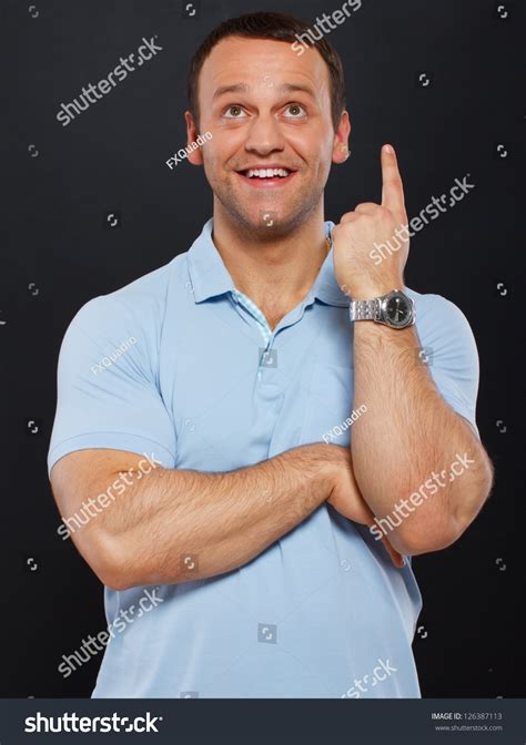 Handsome Man Pointing At Sky Over A Black Background Stock Photo 126387113 : Shutterstock