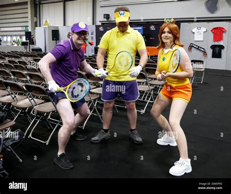 Cosplayers dressed as Waluigi, Wario and Princess Daisy from the ...