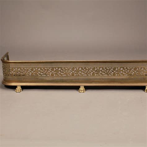 LOT 236 BRASS “D” SHAPED FIREPLACE FENDER WITH PIERCED DESIGN. 7-1/2″(H), 48″(W), 12″(D)