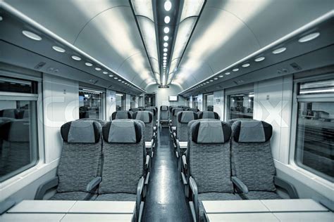 Interior view of modern intercity high speed train coach with rows of ...