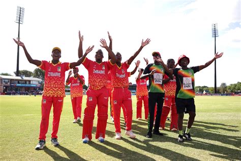 The Zimbabwe players celebrate in front of their supporters ...